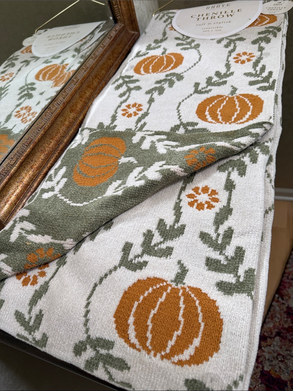 Grove Colkective  Chenille Throw. Off-white with Orange Pumpkins & Green Vines.
